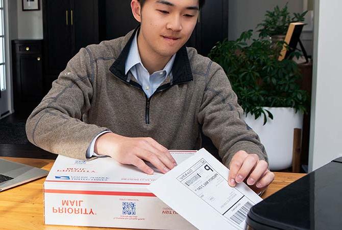 Person printing a Click-N-Ship label for a Priority Mail package.